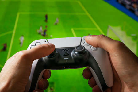 Man playing football game with Playstation 5 controller. 25 Jun, 2021, Sao Paulo, Brazilのeditorial素材