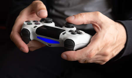 Man holding white Playstation 4 controller - Selective Focus, Sao Paulo, Brazil, 23/09/2020のeditorial素材