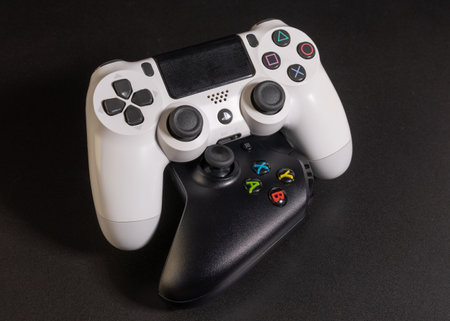 Sao Paulo/Brazil - 08/06/2020: White Playstation 4 and Black Xbox One controller in black...