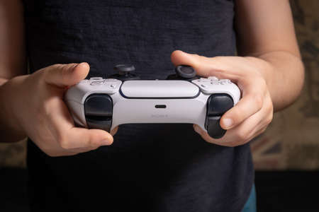 Boy with Playstation 5 controller in your hands - 26 Nov 2020, Sao Paulo, Brazil
