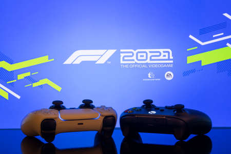 Xbox Series and Playstation 5 controllers with F1 2021 logo at TV screen, 27 Jun, 2021, Sao Paulo,...