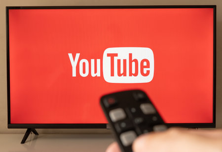 Sao Paulo/SP/Brazil - 08/01/2020: Youtube screen on smart TV with remote control pointing to the tv