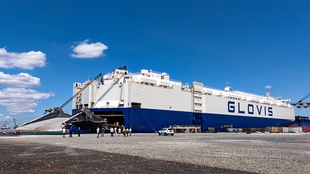 Burgas, Bulgaria - 18th July 2016 Tugboats nudge cargo ship GLOVIS
