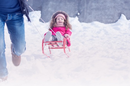 Father and daughter playing in winter snow park