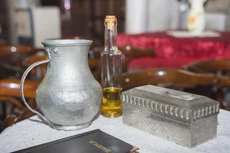 church utensil at the table, glans, the Bible on the table, ceremony of water baptism various objects needed for baptism at Burgasの写真素材