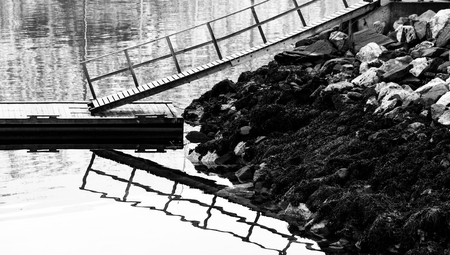 A Jetty Is Reflected In The Waterの写真素材