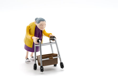 Grandmother with walker, toys, white background, cropped imageの写真素材