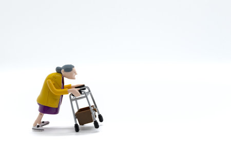 Grandmother with walker, toys, white background, cropped imageの写真素材