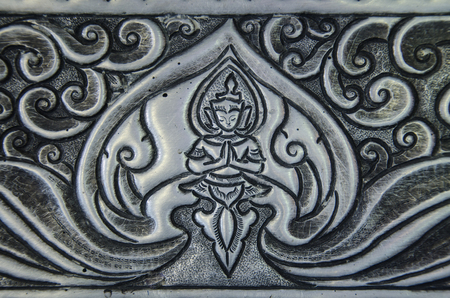 Beautiful Silver Stucco Thai Traditional Art (Lai Thai) Handmade Background Wallpaper Textureの写真素材