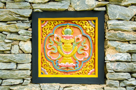 Bhutan Art  Carve on the Stone Wallの写真素材