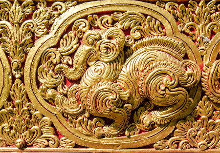 Close Up Beautiful StuccoThai Traditional Art Fantastic Beast or Animal(Lai Thai) Handmade Background Wallpaper Textureの写真素材