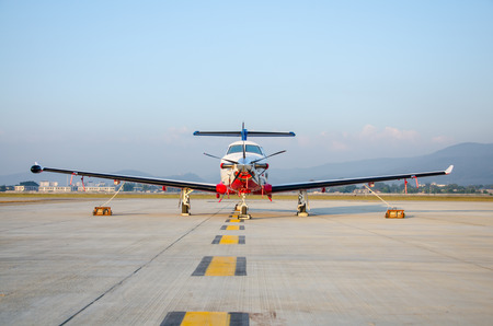 Front of White and Red Small Airplane or Aeroplane Parked at Airport.Small Airplane Famous to use Private Airplane.Mountain View.の写真素材