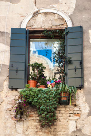Italian window with pots remains impassive to the passage of time