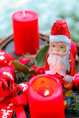 chocolate santa claus at christmas next to candles for christmas decoration Santa Clausの写真素材
