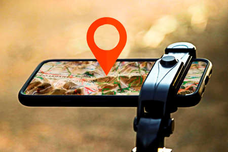 Gps for bicycle with mobile with raised map and position pointing iconの写真素材