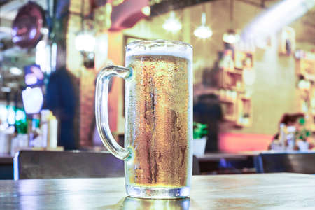 Cold beer mug on bar table ready to drinkの写真素材