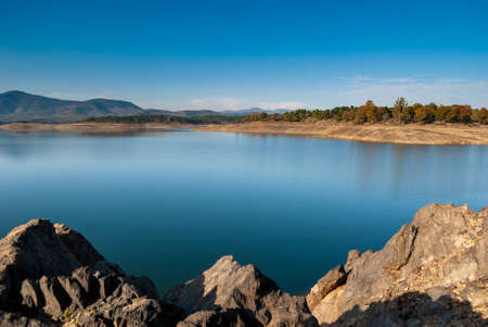 Rocks on the shore of the Gabriel and Galan reservoir in Extremadura, drought, horizontal