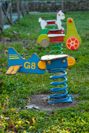 Seesaw swings with wooden spring in children is playground in row in multicolored vertical