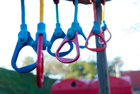 Multicolored gymnastic rings in a playground for outdoor sports, with a white background...