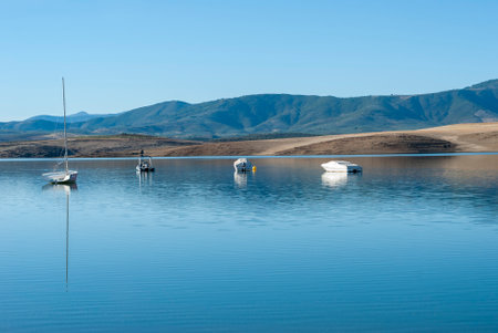 boat and sailboats in swamp on sunny day blue sky horizontal Extremaduraの写真素材