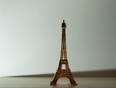 Replica Eiffel Tower in shiny gold on white background in horizontalの写真素材