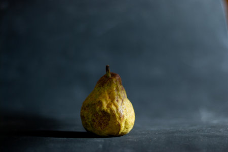Ripe pear on dark background horizontal about to spoilの写真素材