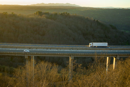 Truck on viaduct on the highway of La Plata, Salamanca dazzled by the sun
