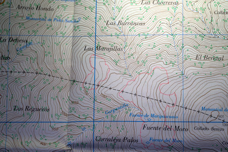 Close up view of a detailed paper topographic map showing contour lines, river details, and symbols. The image serves as an educational example for learning map reading and geographic features.の写真素材