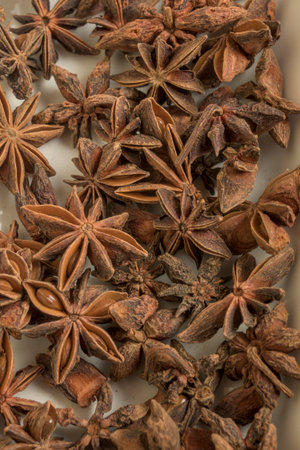 Detailed closeup of dried star anise spice showing natural texture and warm brown tones ideal for culinary and food related conceptsの写真素材