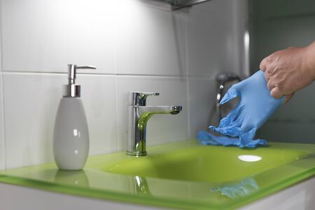 person putting mittens after washing handsの写真素材