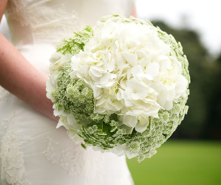 Beautiful and colourful bouquet of flowers on bride´s handsの写真素材