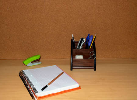 Desk, with writing material, notebook, pencils