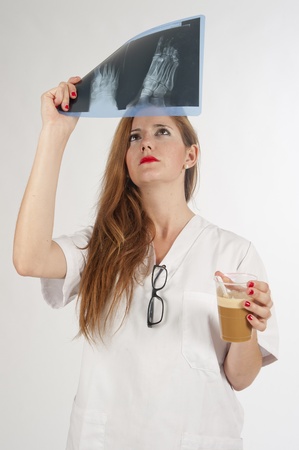 Doctor examining an X-ray redhead, and a coffee の写真素材