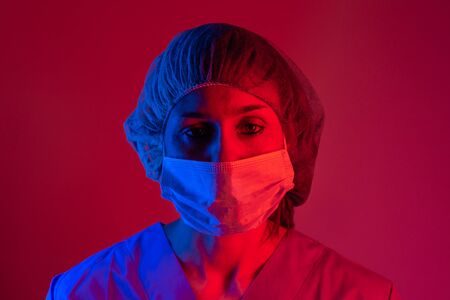 Nurse wearing respirator mask holding a blood test for the new Coronavirus, covid-19. Coronavirus Pandemic Concept.の写真素材