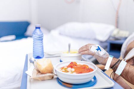Patient eating in the hospital room. Hospitalization and medical care concept.の写真素材