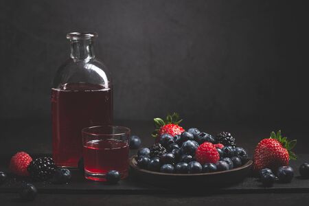 Red fruit detox juice with berries on dark background.の写真素材