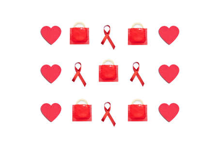 Red hearts, condoms and AIDS red ribbons on white background. World AIDS concept.の写真素材