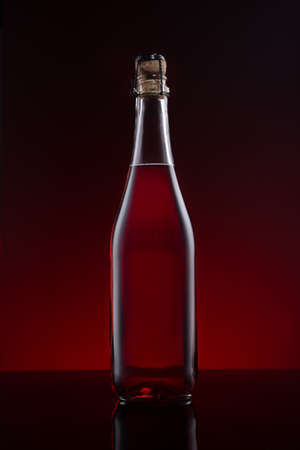 Bottle of Lambrusco wine on red dark background.の写真素材