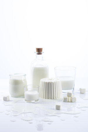 White dairy products in glass recipients on white background vertical format.の写真素材