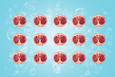 Symmetrical composition of pomegranate slices on blue background. Top view.の写真素材
