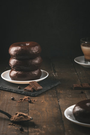 Stack of chocolate donuts on dark background. Vertical format.の写真素材