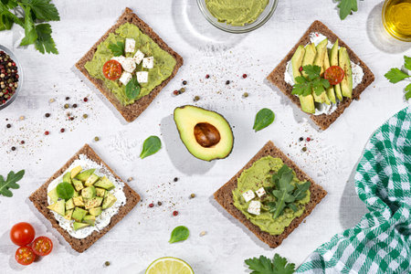 Flat lay composition of avocado toast on light base. Vertical format.