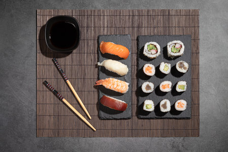 Variety of Fresh sushi and japanese tea on dark background with copyspace.の写真素材