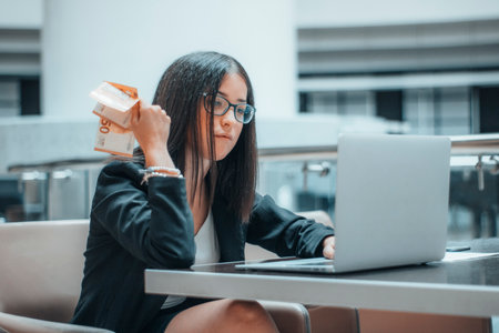 Working woman manages to earn money online in a professional wayの写真素材