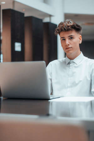 Young handsome businessman sitting professionally working with computer