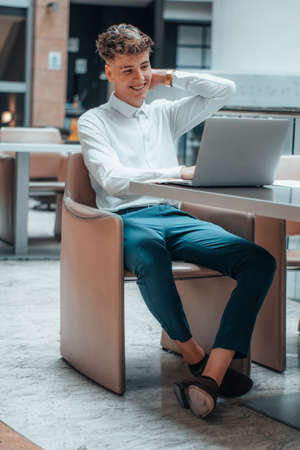 Young businessman manages to earn money online with his computerの写真素材