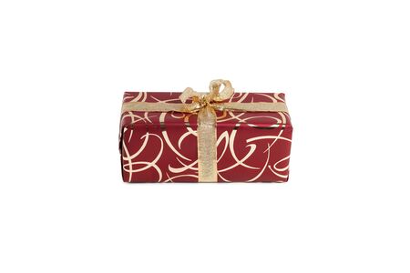 packaged rectangular gift in burgundy packaging with gold bow and gold pattern on a white backgroundの写真素材