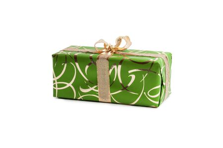 packaged rectangular gift in green packaging with gold bow and gold pattern on a white backgroundの写真素材
