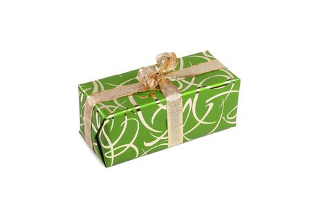 packaged rectangular gift in green packaging with gold bow and gold pattern on a white backgroundの写真素材