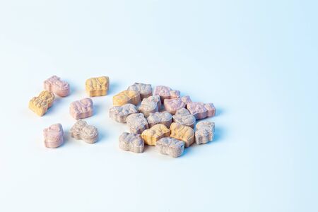 childrens vitamins in the form of animals on a white background with a light blue colorの写真素材